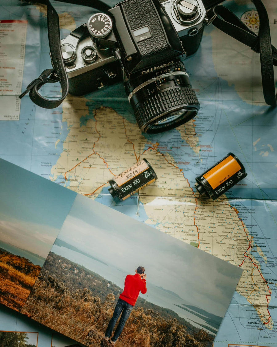 Small printed photographs arranged in sequence on a wooden table