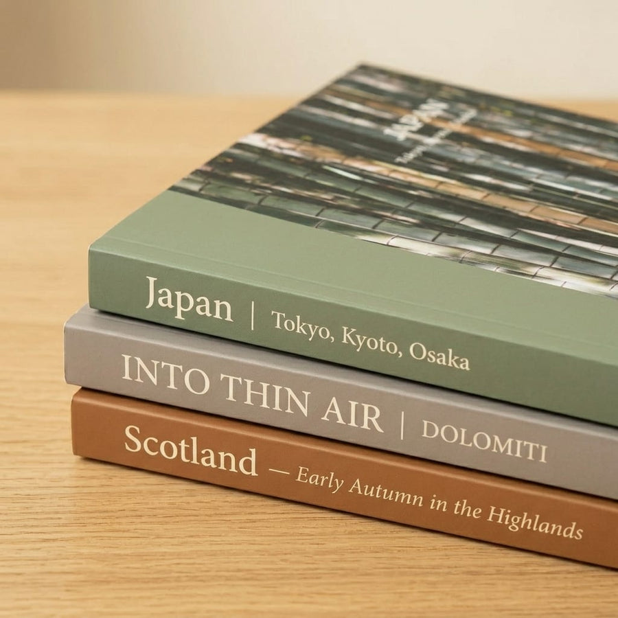 Several photo books from different services arranged on a table for comparison