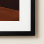 Framed abstract art with black frame on a beige wall