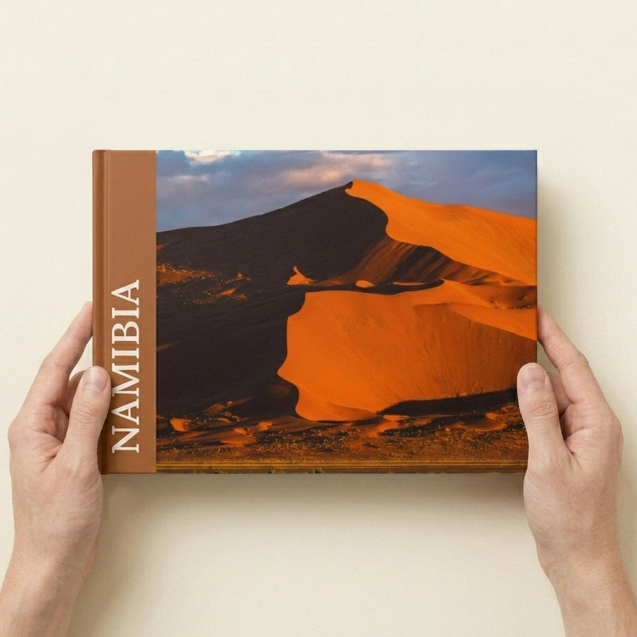 Layflat Edition photo book in A4 landscape held in hands to show physical size