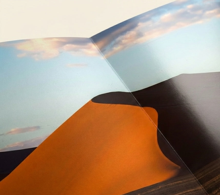 Layflat Edition photo book opened to a two-page panoramic spread, pages laying perfectly flat