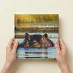 Premium Hardcover photo book in 8-inch square held in hands to show physical size