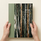 Book cover with bamboo design and 'Japan' text held by hands on a beige background