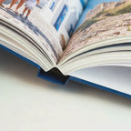 Premium Hardcover photo book being opened, showing matte cover and PUR binding