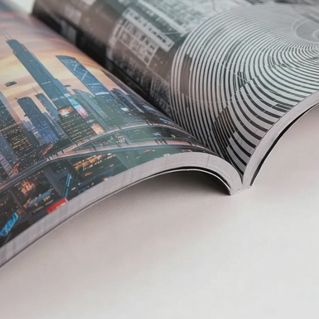 Studio Softcover photo book being opened, showing flexible matte cover and PUR binding